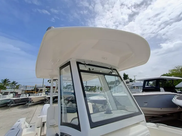 270-152 Yacht Photos Pics 2025 Robalo R270 Center Console boat with T-top under a partly cloudy sky.