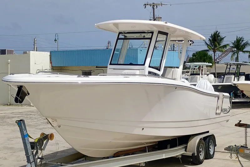 270-152 Yacht Photos Pics 2025 Robalo R270 Center Console boat on trailer, parked outdoors.