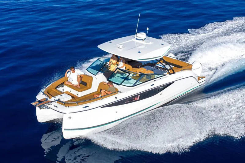  Yacht Photos Pics Manufacturer Provided Image: 2026 Jeanneau TH33 cruising on open water with passengers enjoying the ride.