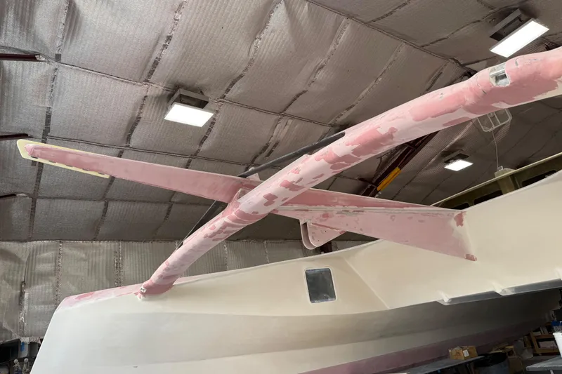  Yacht Photos Pics 2026 Schionning Arrow 1280 S catamaran under construction in a workshop.