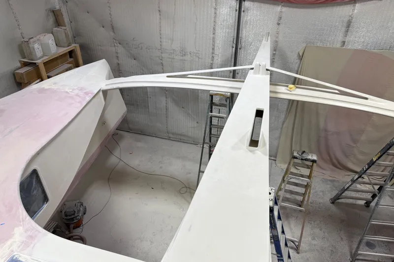  Yacht Photos Pics 2026 Schionning Arrow 1280 S catamaran under construction in a workshop.