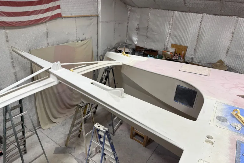  Yacht Photos Pics 2026 Schionning Arrow 1280 S catamaran under construction in a workshop.