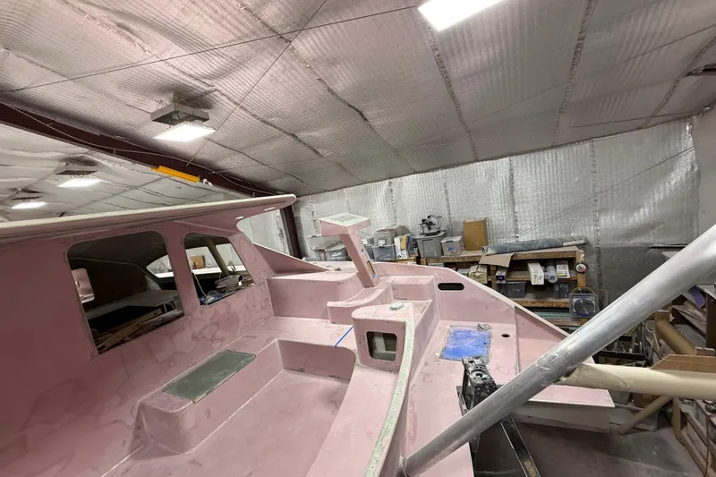  Yacht Photos Pics 2026 Schionning Arrow 1280 S catamaran under construction in a workshop.