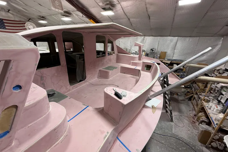  Yacht Photos Pics 2026 Schionning Arrow 1280 S catamaran under construction in a workshop.