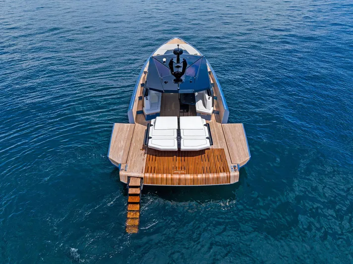  Yacht Photos Pics 2023 Wally WALLYPOWER58 yacht on open water, featuring sleek design and wooden deck.