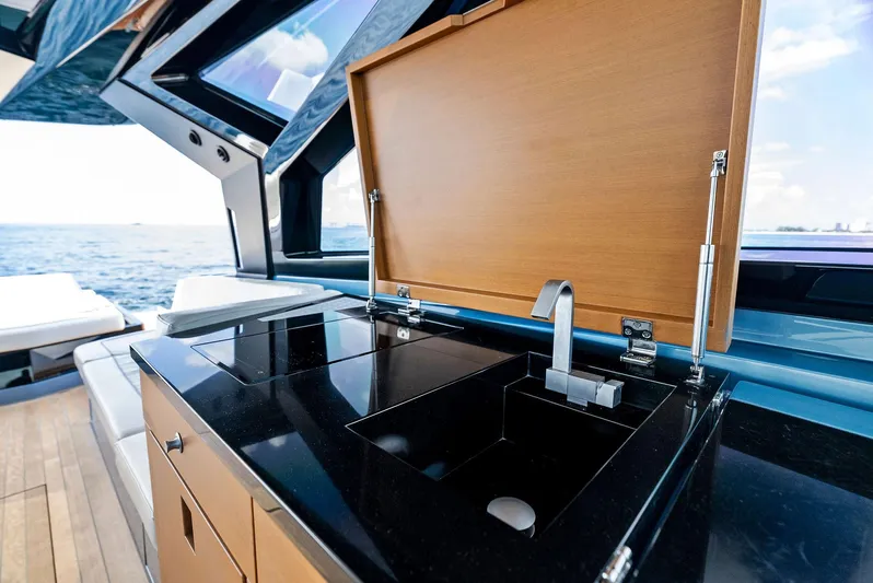  Yacht Photos Pics Luxurious 2023 Wally WALLYPOWER58 yacht kitchen with sleek black countertop and modern sink.