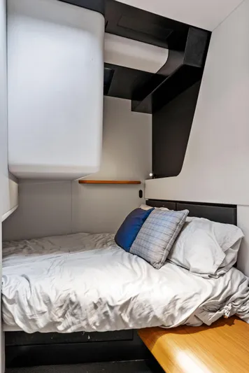  Yacht Photos Pics Modern cabin interior of 2023 Wally WALLYPOWER58 yacht with cozy bed and sleek design.