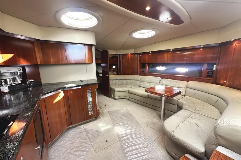  Yacht Photos Pics Luxurious interior of 2007 Cruisers Yachts 540 Express with leather seating and wooden cabinetry.