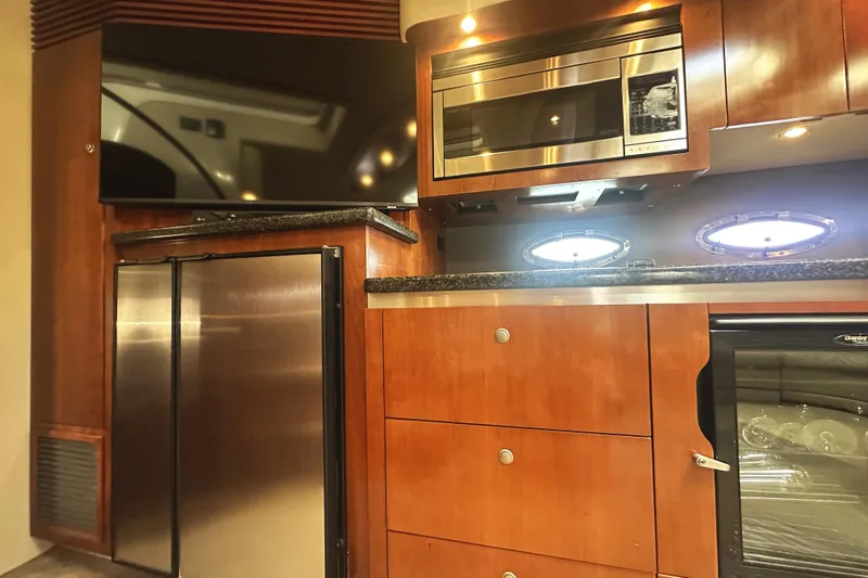  Yacht Photos Pics Luxurious 2007 Cruisers Yachts 540 Express kitchen with modern appliances and wood cabinetry.