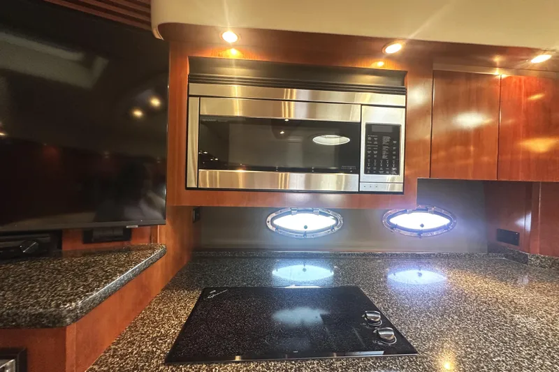  Yacht Photos Pics Luxurious 2007 Cruisers Yachts 540 Express kitchen with modern appliances and sleek design.