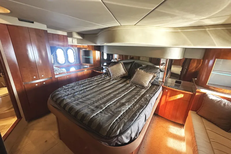  Yacht Photos Pics Luxurious 2007 Cruisers Yachts 540 Express bedroom with elegant wood finishes and plush bedding.
