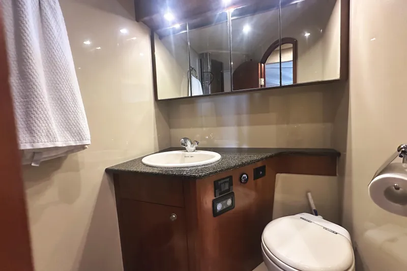  Yacht Photos Pics Luxurious bathroom in 2007 Cruisers Yachts 540 Express with modern fixtures and elegant design.