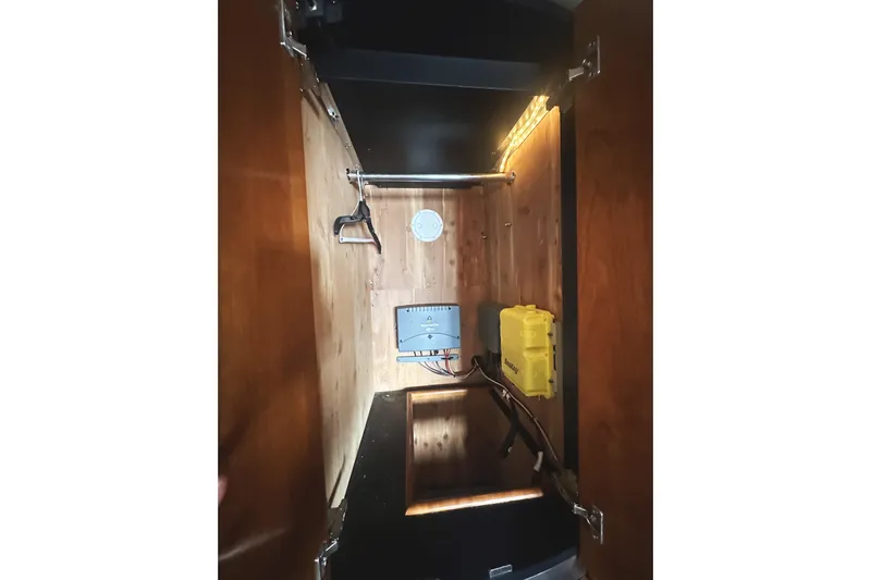  Yacht Photos Pics 2007 Cruisers Yachts 540 Express interior storage with electrical components and lighting.