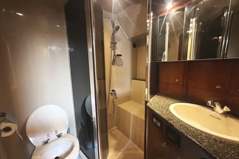  Yacht Photos Pics Luxurious bathroom in 2007 Cruisers Yachts 540 Express, featuring shower, sink, and toilet.