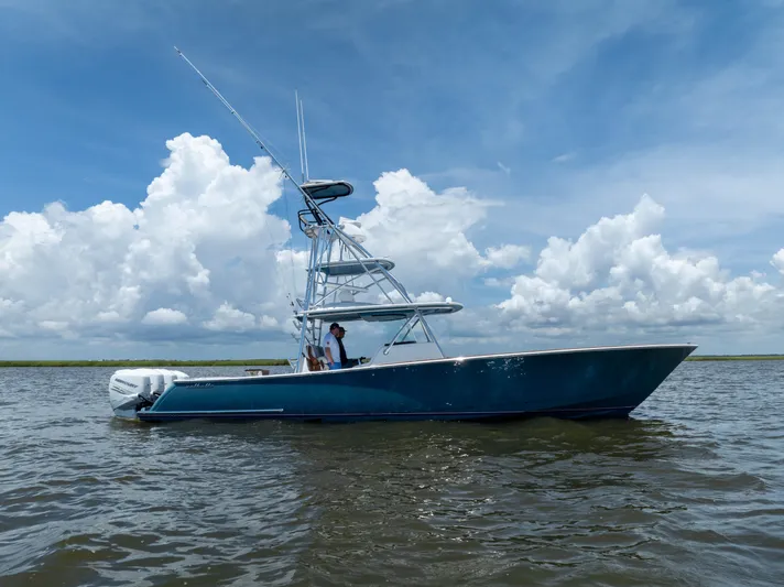 Patriot Yacht Photos Pics 2022 Valhalla Boatworks V41 on water under blue sky with clouds.