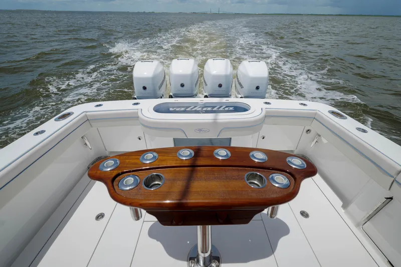Patriot Yacht Photos Pics 2022 Valhalla V41 boat with four engines, wooden table, cruising on open water.