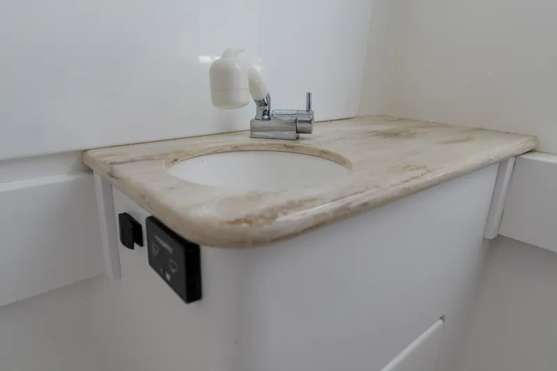 Patriot Yacht Photos Pics 2022 Valhalla Boatworks V41 bathroom sink with faucet and control panel.