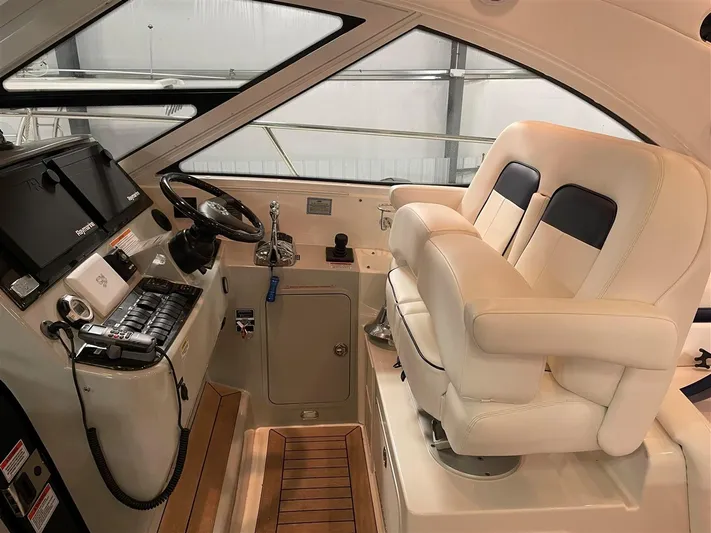 Lightning Strike Yacht Photos Pics 2009 Sea Ray 43 Sundancer helm with dual captain's chairs and modern navigation equipment.