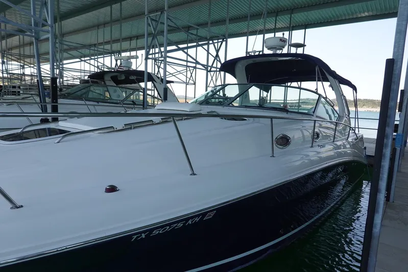  Yacht Photos Pics 2005 Sea Ray 340 Sundancer docked in a marina, featuring sleek design and spacious deck.