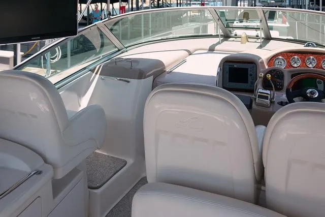  Yacht Photos Pics 2005 Sea Ray 340 Sundancer cockpit with helm, seating, and navigation equipment.