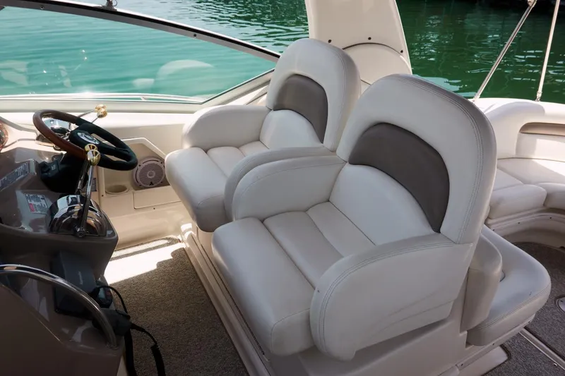  Yacht Photos Pics 2005 Sea Ray 340 Sundancer cockpit with plush white seating and steering wheel.