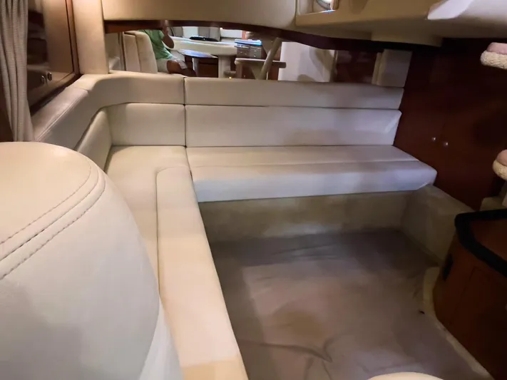  Yacht Photos Pics Interior of 2005 Sea Ray 340 Sundancer with cream leather seating and wooden accents.