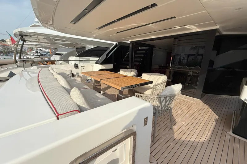 T-b Yacht Photos Pics Luxury outdoor seating on 2022 Sanlorenzo SL96A yacht deck, featuring elegant table and chairs.