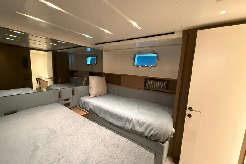T-b Yacht Photos Pics Luxurious cabin interior of 2022 Sanlorenzo SL96A yacht, featuring modern design and cozy bedding.