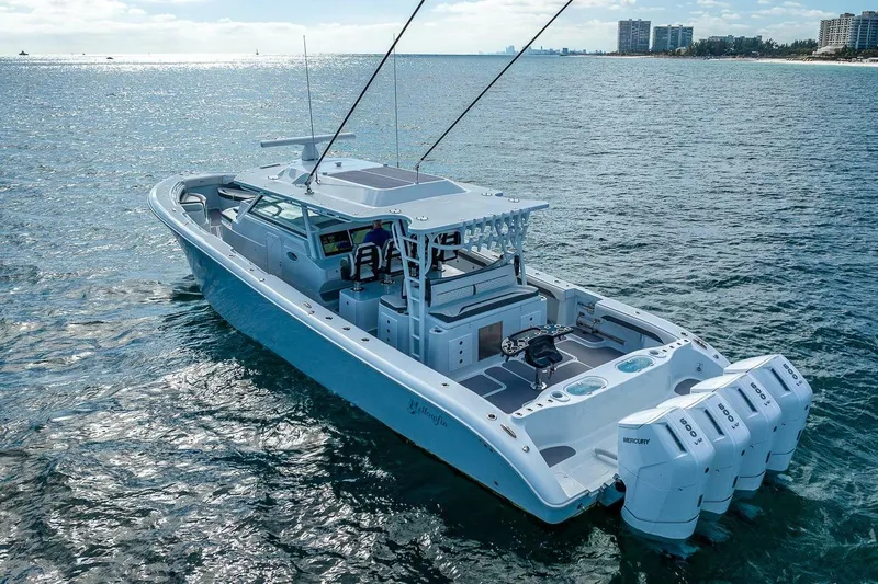  Yacht Photos Pics 2024 Yellowfin 54 Offshore boat cruising on open water, showcasing sleek design and powerful engines.