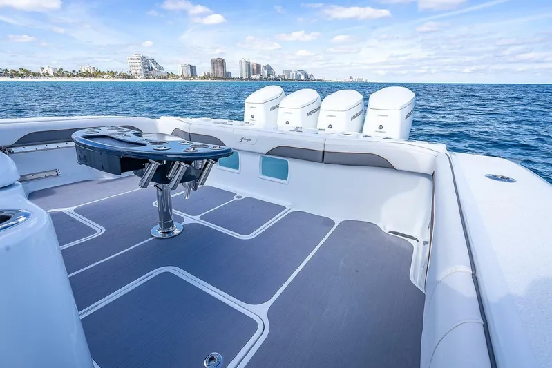  Yacht Photos Pics 2024 Yellowfin 54 Offshore boat deck with ocean view and city skyline.