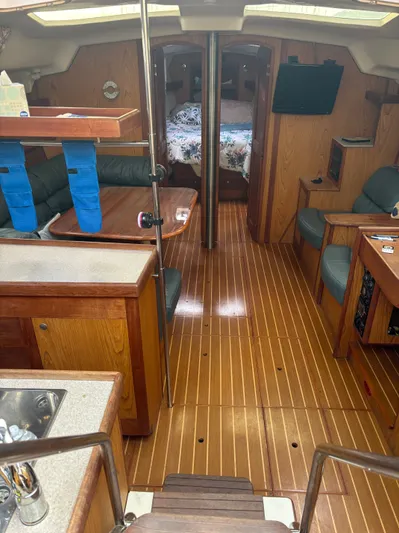 Royal Dawn Yacht Photos Pics Interior of a 2001 Hunter 460 sailboat with wood flooring and cozy seating.