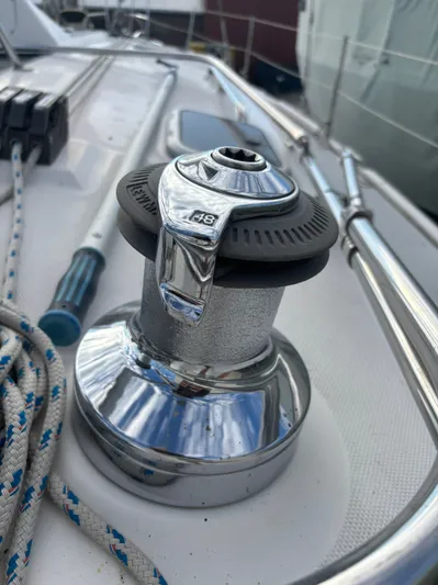 Royal Dawn Yacht Photos Pics Chrome winch on 2001 Hunter 460 sailboat deck with ropes and railing.