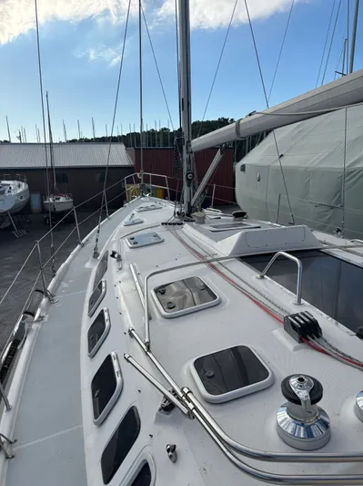 Royal Dawn Yacht Photos Pics 2001 Hunter 460 sailboat deck with hatches, winch, and rigging in a marina setting.