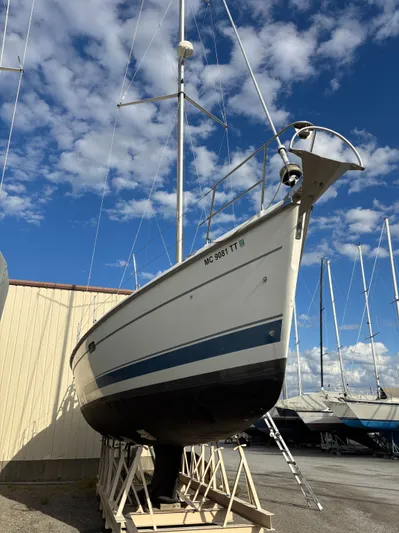 Royal Dawn Yacht Photos Pics 2001 Hunter 460 sailboat on dry dock under a blue sky with scattered clouds.