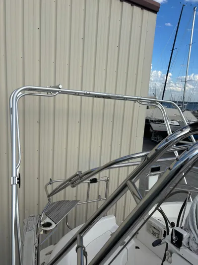 Royal Dawn Yacht Photos Pics Stainless steel frame on a 2001 Hunter 460 sailboat, docked near a beige building.