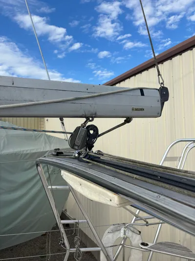 Royal Dawn Yacht Photos Pics Boom and rigging of a 2001 Hunter 460 sailboat against a blue sky.