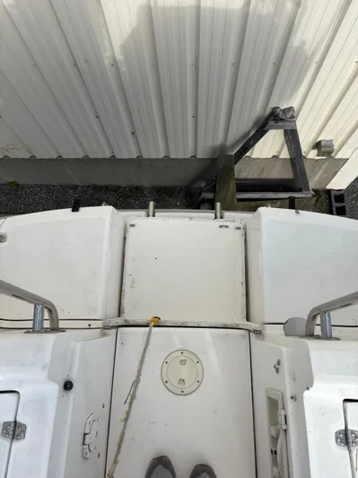 Royal Dawn Yacht Photos Pics Top view of a 2001 Hunter 460 boat deck near a metal building.