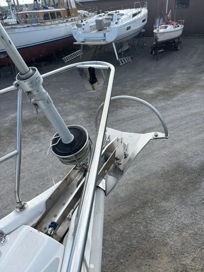 Royal Dawn Yacht Photos Pics Bow of a 2001 Hunter 460 sailboat with anchor, in a boatyard.