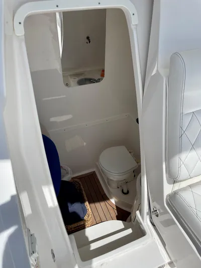  Yacht Photos Pics 2013 Intrepid 375 Center Console boat interior with compact marine toilet.