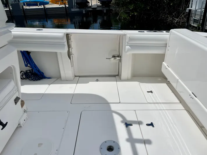  Yacht Photos Pics 2013 Intrepid 375 Center Console boat deck with storage compartments and clean white finish.