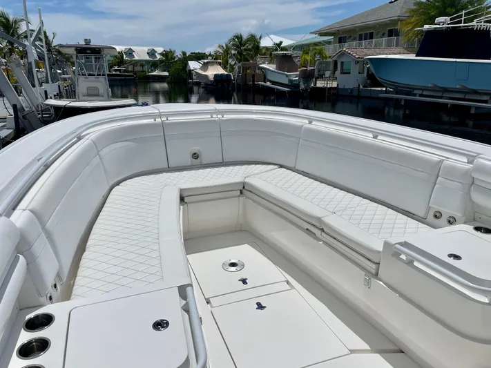  Yacht Photos Pics 2013 Intrepid 375 Center Console boat with spacious seating in a marina setting.