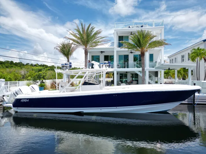 Yacht Photos Pics 2013 Intrepid 375 Center Console boat docked by modern waterfront home.