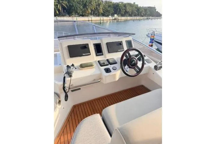  Yacht Photos Pics Cockpit of 2014 Azimut 70 yacht with modern controls and wooden flooring.