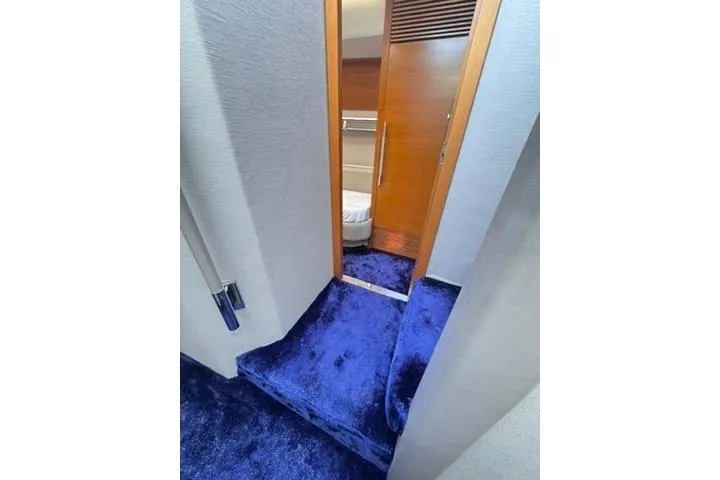  Yacht Photos Pics Interior of 2014 Azimut 70 yacht with blue carpet and wooden door.