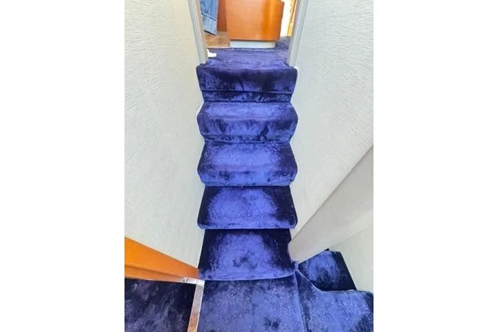  Yacht Photos Pics Luxurious blue carpeted stairs inside a 2014 Azimut 70 yacht.