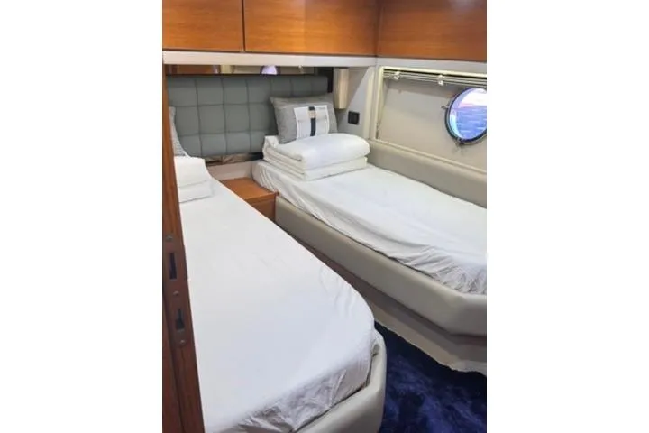  Yacht Photos Pics Luxurious twin cabin interior of 2014 Azimut 70 yacht with porthole view.