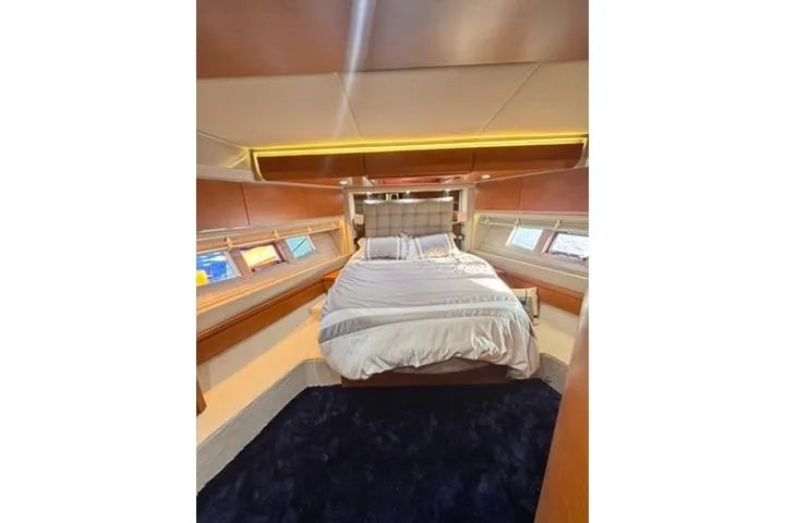  Yacht Photos Pics Luxurious bedroom interior of 2014 Azimut 70 yacht with elegant bedding and ambient lighting.