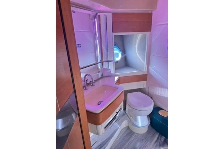  Yacht Photos Pics Luxurious bathroom in 2014 Azimut 70 yacht with modern fixtures and ambient lighting.