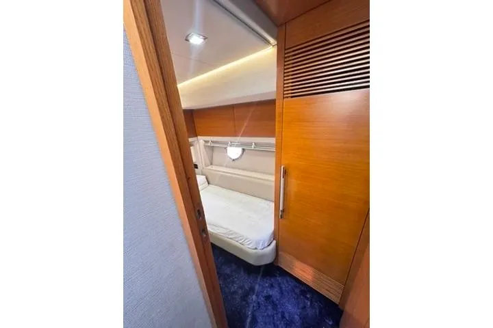  Yacht Photos Pics Luxurious cabin interior of 2014 Azimut 70 yacht with wooden finishes and cozy bed.