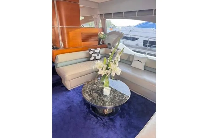  Yacht Photos Pics Luxurious interior of a 2014 Azimut 70 yacht with elegant seating and floral centerpiece.